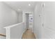 Upstairs hallway features neutral carpet, white walls, and open bedroom doorway at 1900 Fishamble St # 17, Fuquay Varina, NC 27526