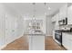 Open-concept kitchen with stainless steel appliances and a large island with granite countertops at 1900 Fishamble St # 17, Fuquay Varina, NC 27526