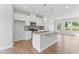 Modern kitchen features granite counters, stainless appliances, island with sink, and pendant lighting at 1900 Fishamble St # 17, Fuquay Varina, NC 27526