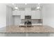 Kitchen featuring a large island with granite countertops, stainless steel appliances, and pendant lighting at 1900 Fishamble St # 17, Fuquay Varina, NC 27526