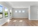Bright living room featuring hardwood floors and multiple windows for ample natural light at 1900 Fishamble St # 17, Fuquay Varina, NC 27526