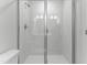 Modern shower with glass doors, white tile, chrome fixtures, and shower head at 1900 Fishamble St # 17, Fuquay Varina, NC 27526