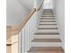 Elegant staircase with hardwood treads, white risers, and a wood handrail at 1900 Fishamble St # 17, Fuquay Varina, NC 27526