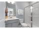 Modern bathroom with a glass-enclosed shower, gray vanity, and soft blue walls, offering a serene space at 1924 Fishamble # 23, Fuquay Varina, NC 27526