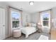 Cozy bedroom featuring a white crib, natural light, and neutral decor at 1924 Fishamble # 23, Fuquay Varina, NC 27526