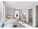 Bright bedroom with a white crib, a natural light window, and access to bathroom at 1924 Fishamble # 23, Fuquay Varina, NC 27526