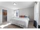 Bright bedroom with a large bed, natural light, and access to hallway at 1924 Fishamble # 23, Fuquay Varina, NC 27526