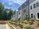 Exterior view showcases the back of the townhomes with gray siding and green space between units at 1924 Fishamble # 23, Fuquay Varina, NC 27526