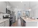 Spacious kitchen features stainless steel appliances, an island with pendant lighting, and modern finishes at 1924 Fishamble # 23, Fuquay Varina, NC 27526