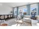 Bright living room featuring large windows, stylish furniture, and a cozy atmosphere for relaxation and entertainment at 1924 Fishamble # 23, Fuquay Varina, NC 27526