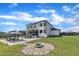 Expansive backyard featuring a modern white home, outdoor seating, and a fire pit area for entertaining at 2004 Yamacraw Dr, Knightdale, NC 27545