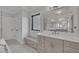 Bathroom featuring a vanity with stone countertop, window, built-in bench seating, and white cabinets at 2004 Yamacraw Dr, Knightdale, NC 27545