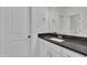 Well-lit bathroom with bright white cabinets and a dark stone countertop at 2004 Yamacraw Dr, Knightdale, NC 27545