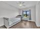 A bright bedroom featuring a daybed, a ceiling fan and a large window at 2004 Yamacraw Dr, Knightdale, NC 27545