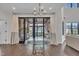 Open dining area with glass table, hanging chair, and views of outdoor living space at 2004 Yamacraw Dr, Knightdale, NC 27545