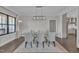 Bright dining room featuring a glass-top table, seating for six, and a modern light fixture at 2004 Yamacraw Dr, Knightdale, NC 27545