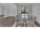 Elegant dining room with a large glass-top table, seating for ten, and a modern chandelier at 2004 Yamacraw Dr, Knightdale, NC 27545
