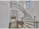 Elegant foyer with curved staircase, beautiful chandelier, and hardwood floors at 2004 Yamacraw Dr, Knightdale, NC 27545