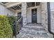 Inviting front entrance with stone steps, decorative wreath, and covered porch with pendant lights at 2004 Yamacraw Dr, Knightdale, NC 27545