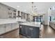 A modern kitchen with stainless steel appliances, gray cabinets, an island, and access to the backyard at 2004 Yamacraw Dr, Knightdale, NC 27545