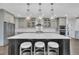 A stylish kitchen features a large island with seating, stainless steel appliances, and pendant lighting at 2004 Yamacraw Dr, Knightdale, NC 27545