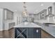 Bright kitchen features an island with a waterfall countertop, wine storage, and gray cabinets at 2004 Yamacraw Dr, Knightdale, NC 27545