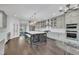 Spacious kitchen with gray cabinets, stainless steel appliances, large island with bar seating, and backyard views at 2004 Yamacraw Dr, Knightdale, NC 27545