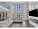 Spacious living room with floor to ceiling fireplace, large windows and a comfortable couch at 2004 Yamacraw Dr, Knightdale, NC 27545