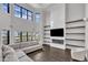 Bright living room with a modern fireplace, large windows, and comfortable sectional sofa at 2004 Yamacraw Dr, Knightdale, NC 27545