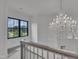 Elegant staircase with a large chandelier and a window overlooking the outdoors at 2004 Yamacraw Dr, Knightdale, NC 27545