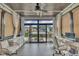 Inviting sunroom with natural light, stylish decor, and a tranquil view at 2004 Yamacraw Dr, Knightdale, NC 27545