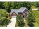Aerial view of a two-story brick home showcasing its well-manicured lawn, driveway, and mature landscaping at 203 Worsham Dr., Chapel Hill, NC 27516