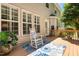 Inviting back porch with a rocking chair, floral rug, and view of the well-maintained home exterior at 203 Worsham Dr., Chapel Hill, NC 27516