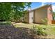 Landscaped backyard featuring a mix of grass, mulch, and tiered garden beds alongside the house at 203 Worsham Dr., Chapel Hill, NC 27516