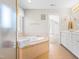 Bright bathroom features a soaking tub with tile surround and large vanity with storage at 203 Worsham Dr., Chapel Hill, NC 27516