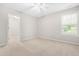 Bright bedroom features neutral carpet, a ceiling fan, and a window with natural light at 203 Worsham Dr., Chapel Hill, NC 27516