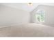 Spacious bedroom featuring vaulted ceiling, a large window, and neutral walls at 203 Worsham Dr., Chapel Hill, NC 27516