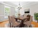 Formal dining room with hardwood floors, elegant chandelier, large table, and refined décor with natural light at 203 Worsham Dr., Chapel Hill, NC 27516
