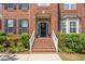 Close-up of the home's entry featuring brick steps, white railings, and attractive landscaping at 203 Worsham Dr., Chapel Hill, NC 27516