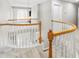 Hallway with curved white railings, a chandelier and views of the downstairs at 203 Worsham Dr., Chapel Hill, NC 27516