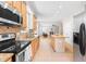 Open-concept kitchen with modern appliances and a seamless flow into the living area at 203 Worsham Dr., Chapel Hill, NC 27516