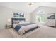 Well-lit main bedroom featuring a large bed, side tables, dressers and a curved window at 203 Worsham Dr., Chapel Hill, NC 27516
