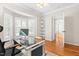 Bright home office with hardwood floors, white plantation shutters, and contemporary glass-top desk at 203 Worsham Dr., Chapel Hill, NC 27516