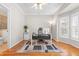 Home office with natural light, featuring hardwood floors, ceiling fan, and stylish desk and decor at 203 Worsham Dr., Chapel Hill, NC 27516