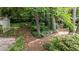 Picturesque backyard with mature trees, a shed, and winding paths, offering a tranquil escape at 205 W Oak Ave, Wake Forest, NC 27587