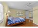 Comfortable bedroom boasts wood floors, ceiling fan, and sunny windows for a relaxing atmosphere at 205 W Oak Ave, Wake Forest, NC 27587