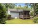 Rear view of the home, featuring a screened porch and lush greenery, creating a private outdoor space at 205 W Oak Ave, Wake Forest, NC 27587