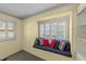 Comfortable window seat with patterned pillows and white shutters, complemented by built-in shelves at 205 W Oak Ave, Wake Forest, NC 27587