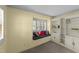 Cozy living room showcasing a window seat with colorful cushions and built-in shelving for storage at 205 W Oak Ave, Wake Forest, NC 27587