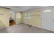 A bright living room with fresh paint and entry door, complete with neutral carpet and open access to adjacent rooms at 205 W Oak Ave, Wake Forest, NC 27587